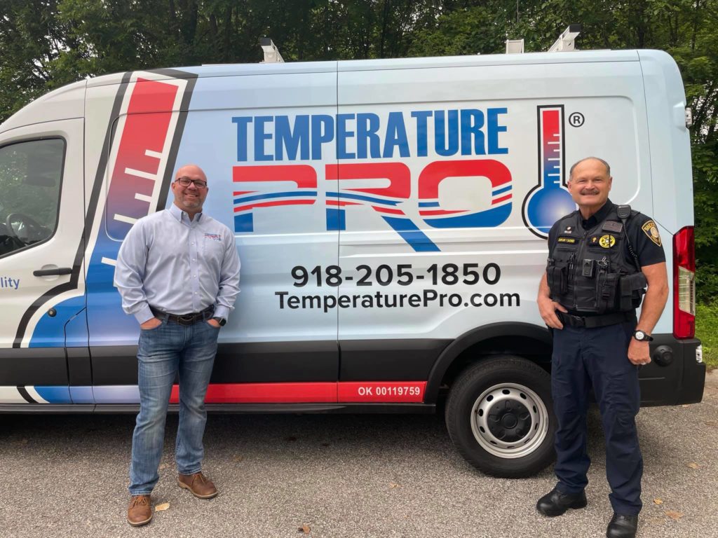 TemperaturePro Tulsa owner w/ police officer in front of work van