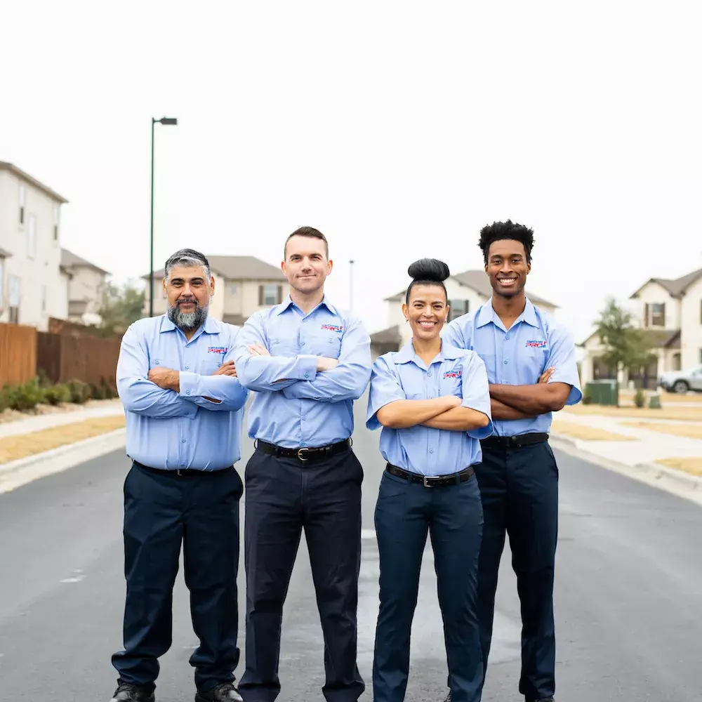 Four AC technicians from TemperaturePro McKinney standing with their arms crossed and smiling.