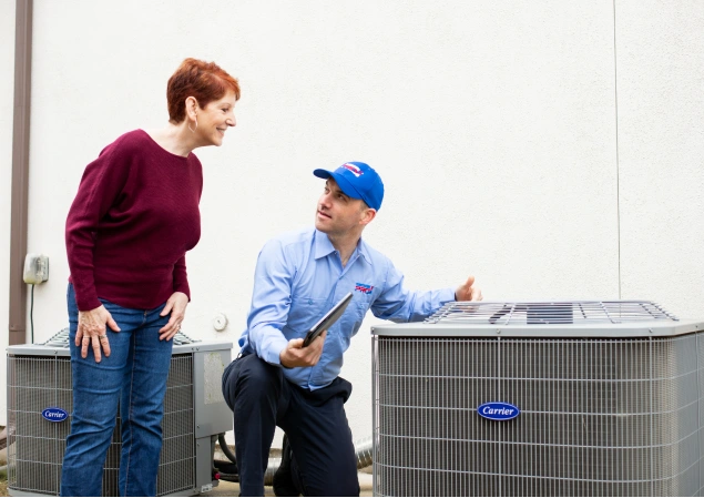 Denham Springs HVAC technicians showing a homeowner the diagnoses of their HVAC unit.