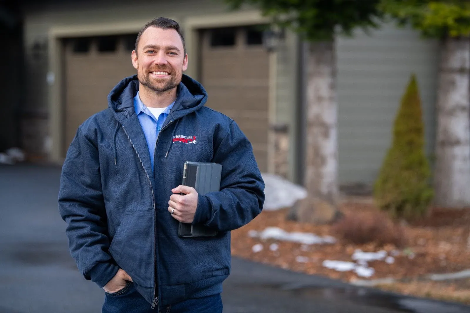 TemperaturePro Inland Northwest heating repair technician standing outside of customers home.
