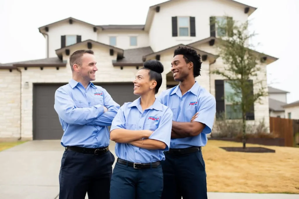 Orlando HVAC technicians standing with arms crossed looking at one another.