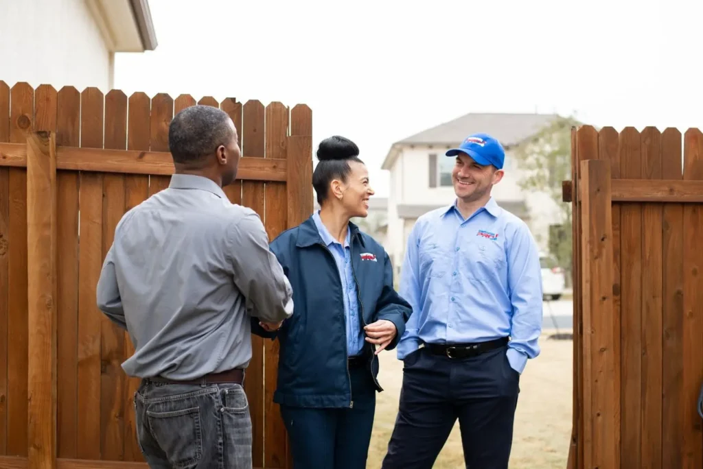 Trinity HVAC technicians shaking hands with homeowner.