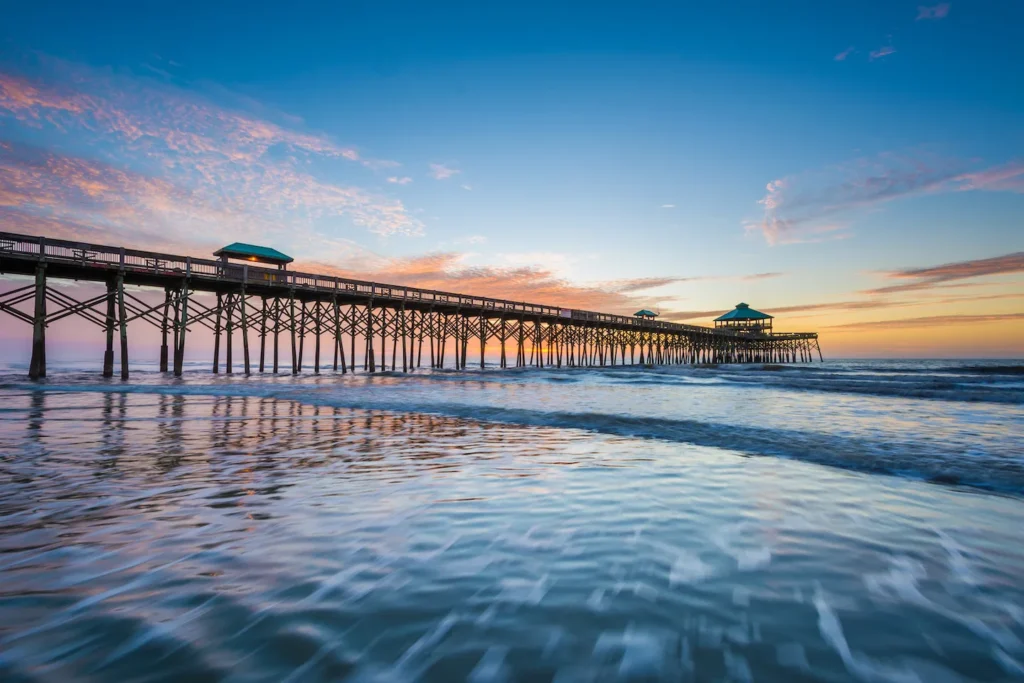 Waves crashing onto shore next to boardwalk in Lowcountry, South Carolina.