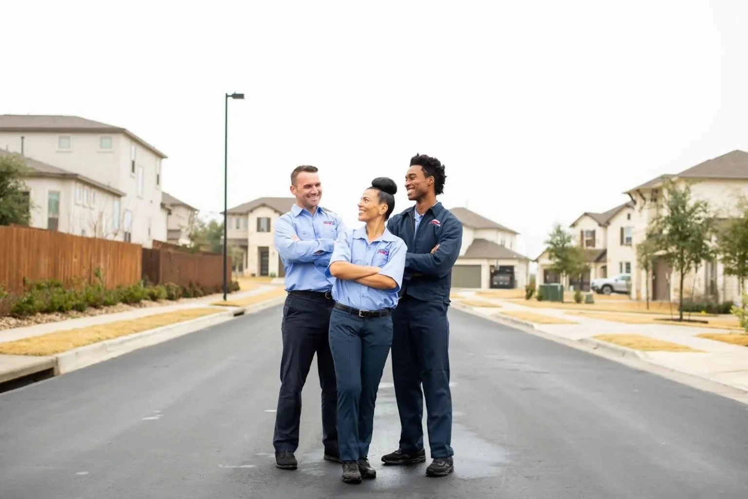 Three San Jose heating technicians from TemperaturePro standing and smiling with arms crossed.