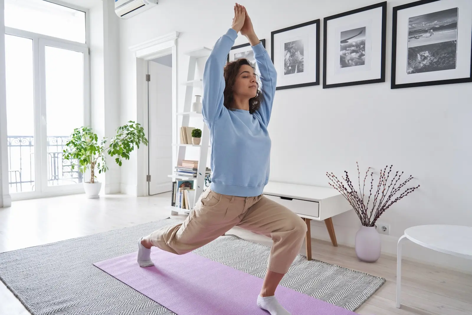 Women doing yoga inside home with improved indoor air quality.