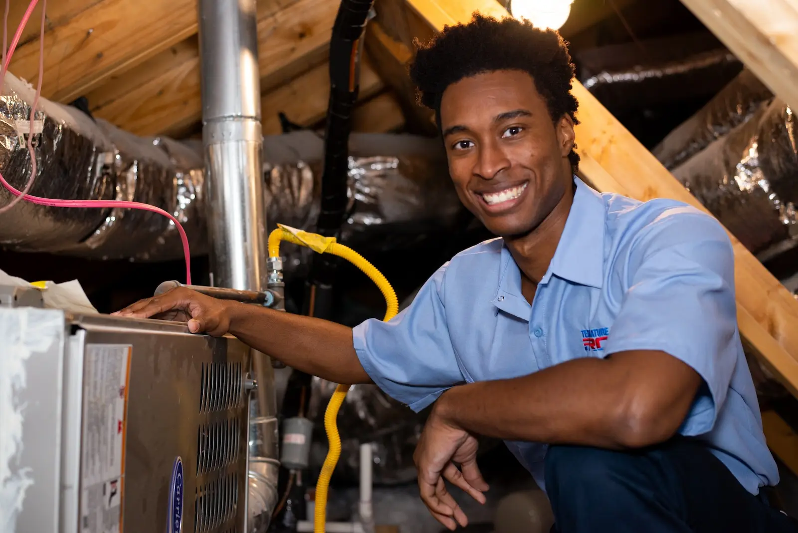 Duct cleaning technician from Temperature Pro San Jose inspection unit inside of an attic.