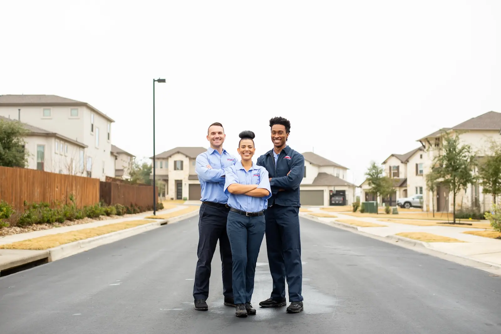 Three Kirkland heating inspection technicians standing in street with arms crossed.