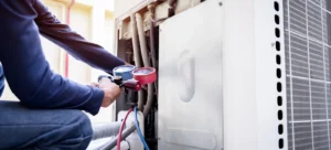 TemperaturePro Seattle heat pump technician using pressure gauge to check HVAC lifespan.