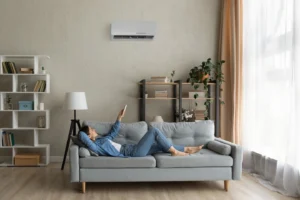 Woman adjusting her AC in comfort.
