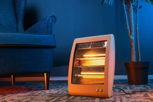 A space heater is turned on and sitting on a carpeted floor inside Saskatchewan home.