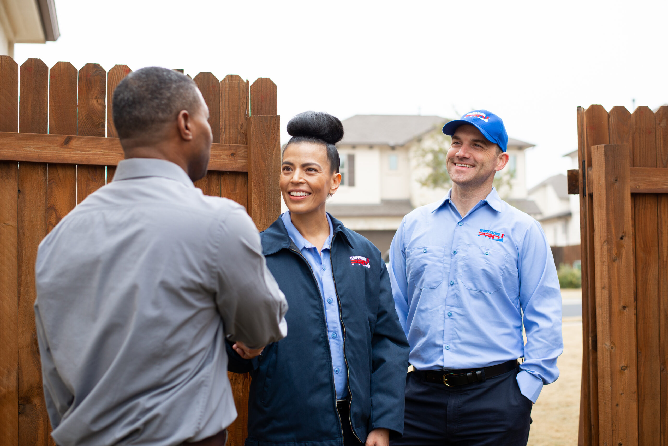 Homeowner greeting TemperaturePro Conroe maintenance techs.