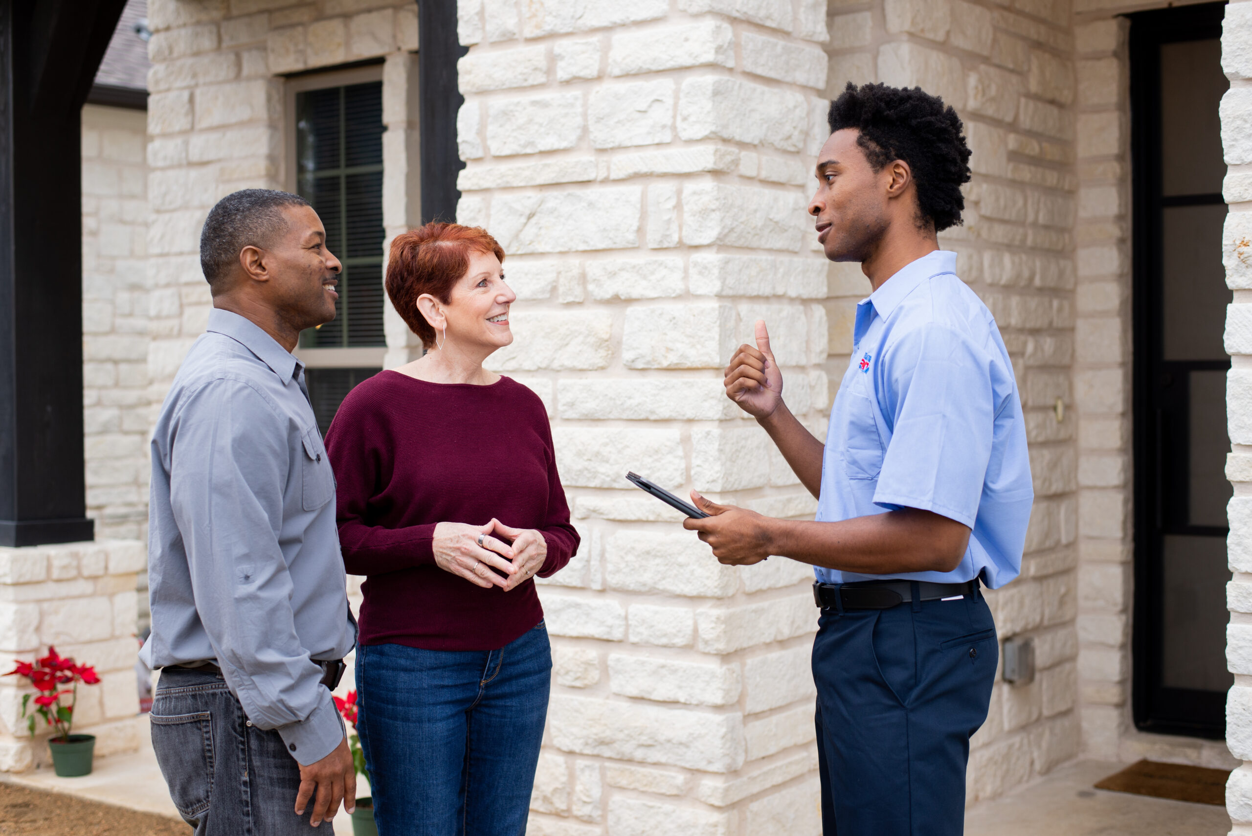 Heating maintenance technician in Conroe, Texas explaining service recommendations to homeowners.