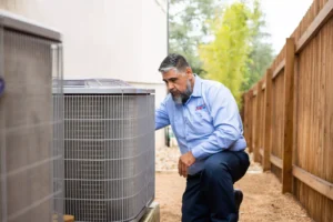HVAC technician in Round Rock inspecting heat pump unit.