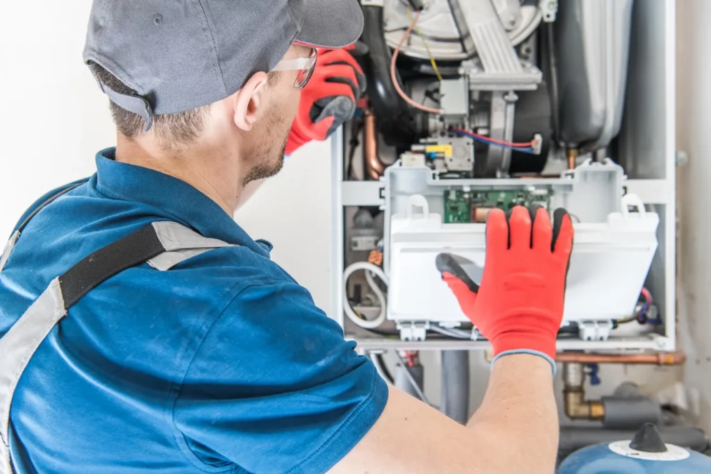 Heater technician testing an indoor unit for issues.