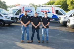 TemperaturePro technicians standing in front of branded service vans