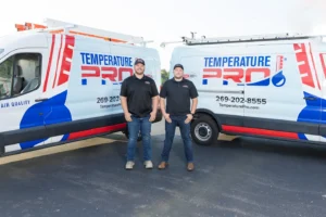 TemperaturePro technicians standing in front of a branded service van