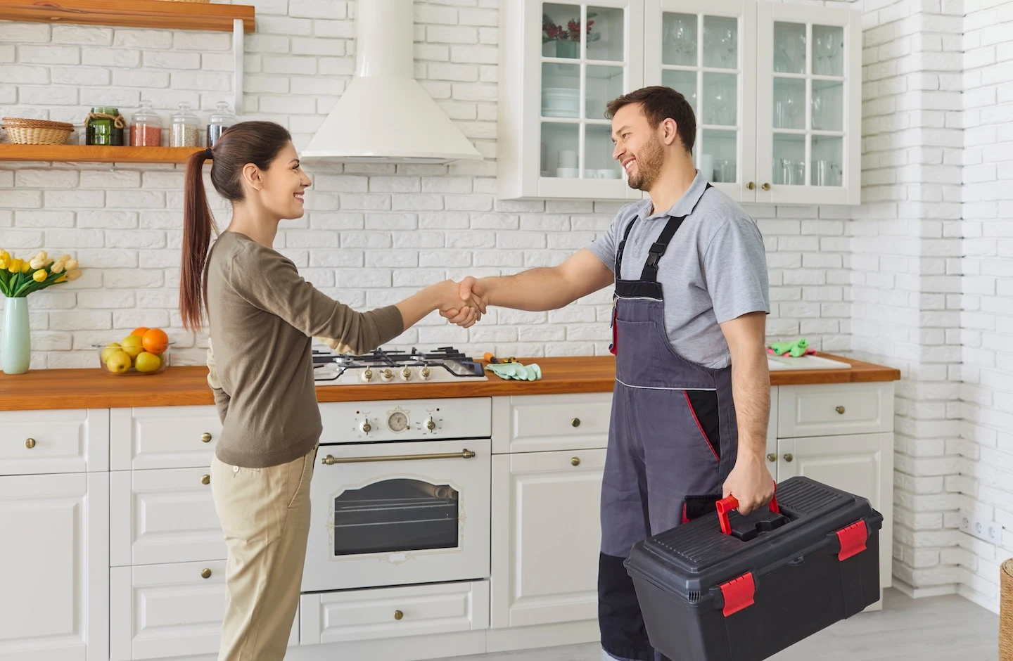 Homeowner greeting an HVAC technician arriving for a service visit